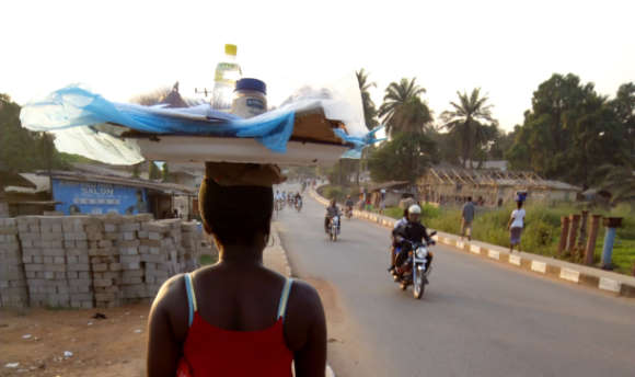 Woman in Kono Sierra Leone carrying supplies on head