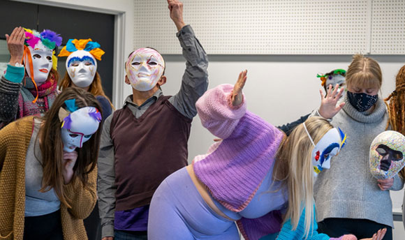 Dramatherapy students performing with a series of different masks on
