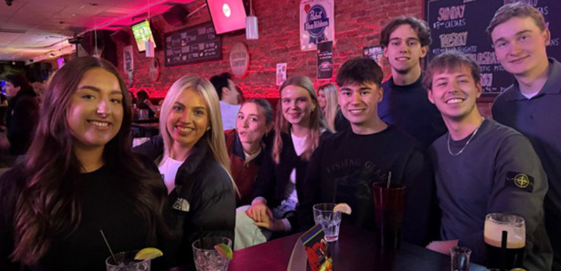 A group of people enjoying drinks at a student bar