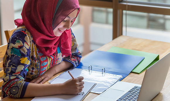Female sitting writing