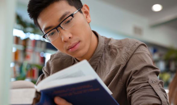 Student reading in library