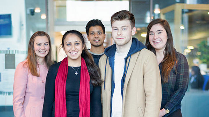 A photo of a group of QMU students looking directly at the camera and smiling