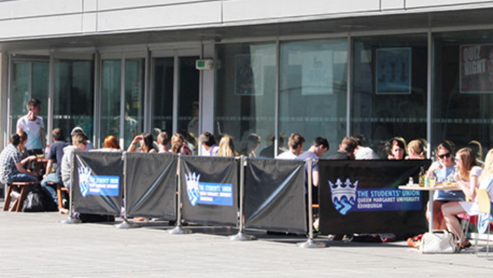 The Queen Margaret University Student Union outdoor seating area full of students
