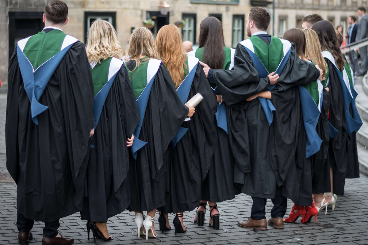 A group of posing QMU Graduates from behind
