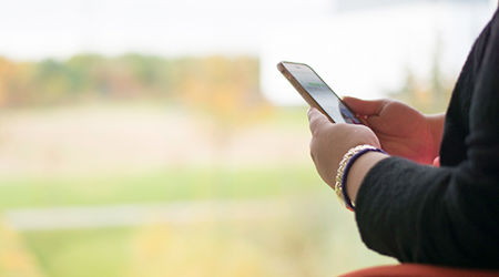 Wide angle view of a person's hands holding their mobile phone
