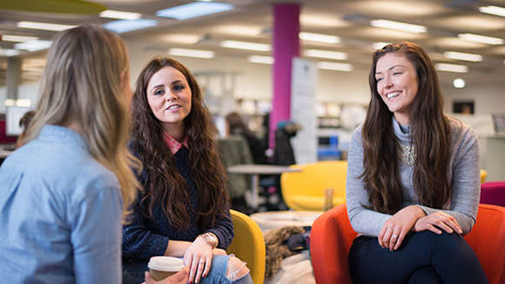 Group of students smiling and talking together, QMU campus, Edinburgh