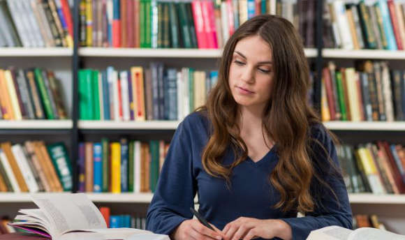 Queen Margaret University student studying in the library