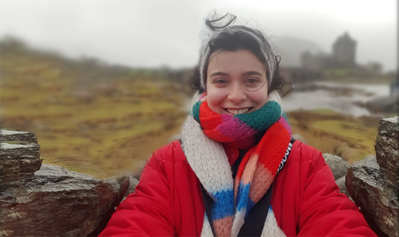 Yeliz taking a self portrait outside in a warm jacket