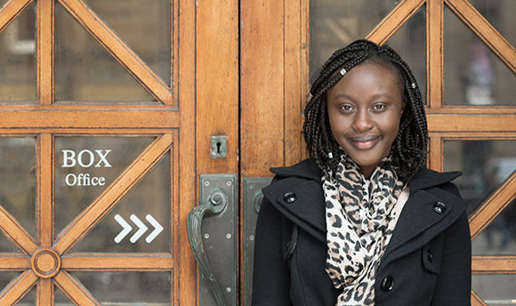 A young student poses in front of the Usher Hall box office