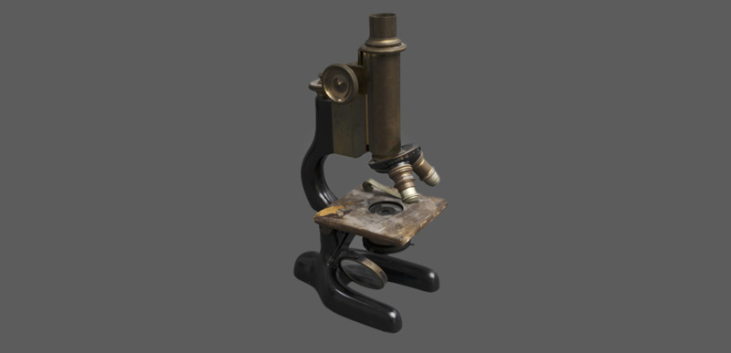 A side-view of a vintage microscope.