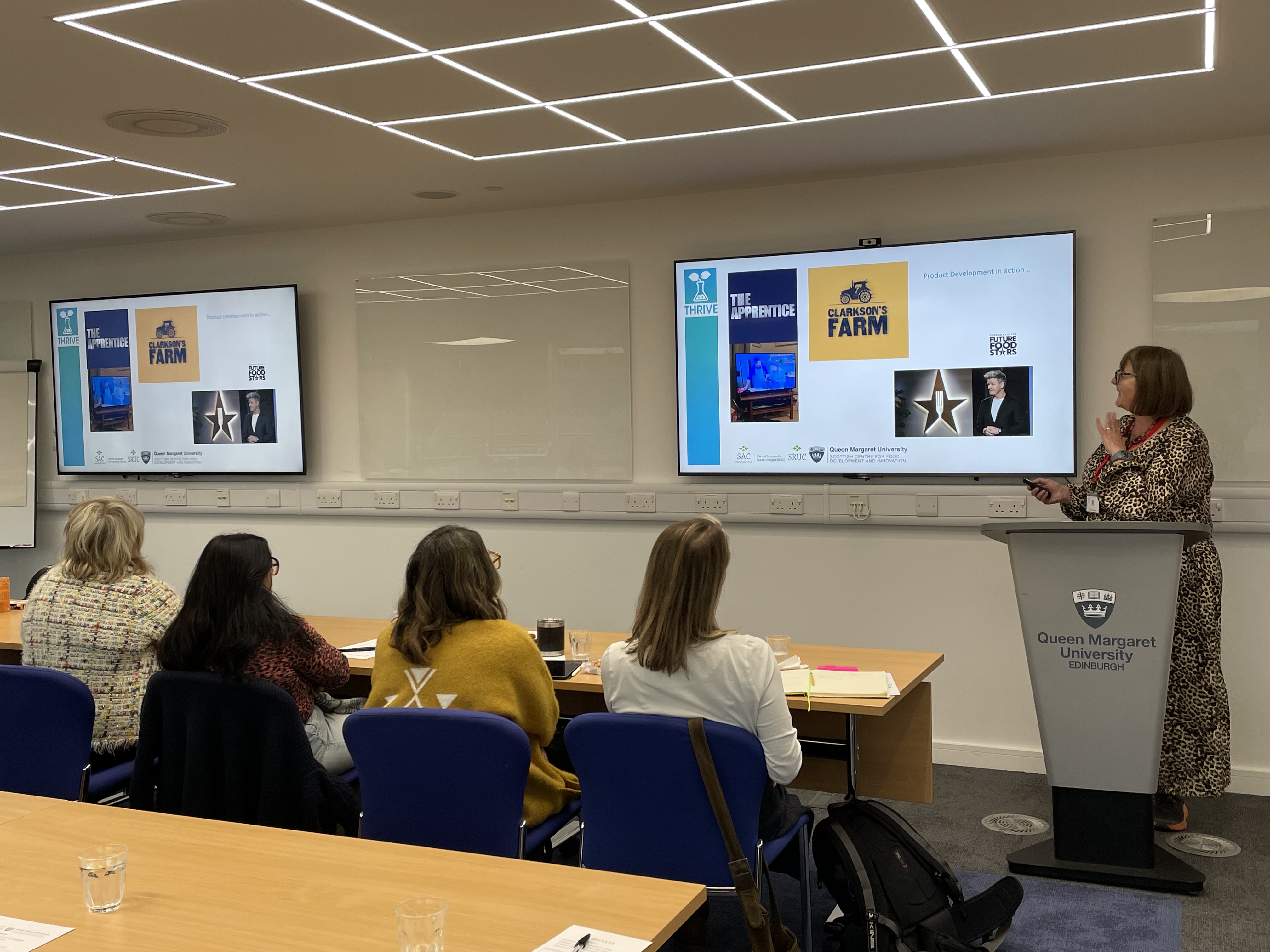 woman presenting on product development to an audience