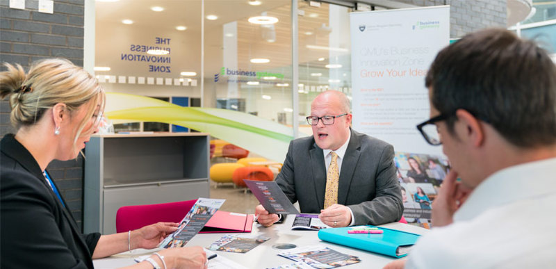 Two members of staff engaged in a meeting with a client at the Business Gateway centre.