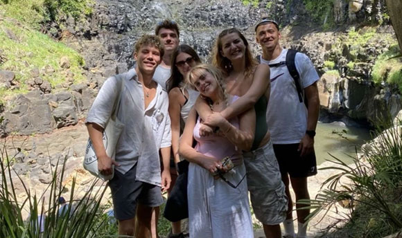 Several young people taking a group photo together