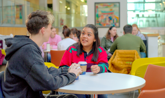 male and female student talking to each other at QMU