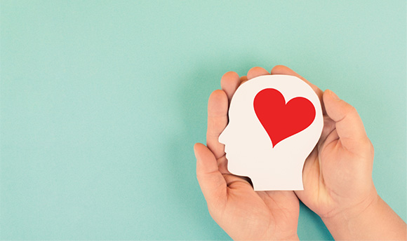 Image of a hand holding a head with a heart on it