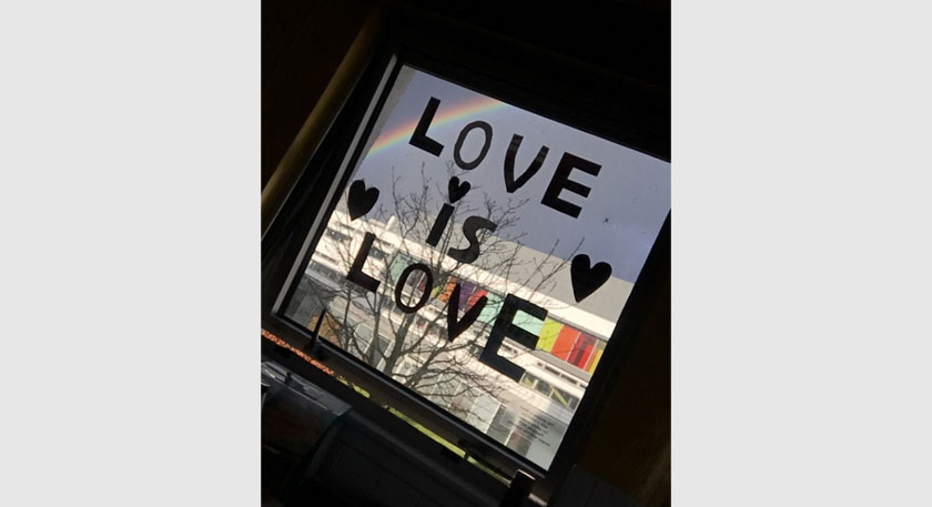 A window with 'Love is Love' written on it