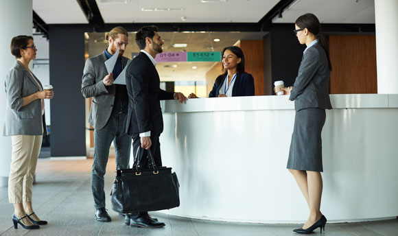 Business people standing at a hotel reception