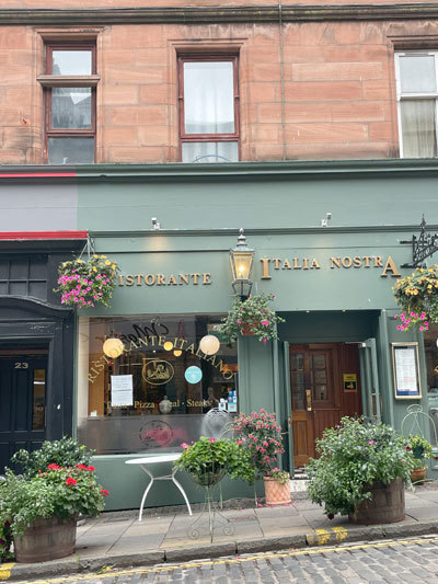 The shopfront of a stylish Italian restaurant on a cobbled street in Stirling
