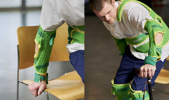 A person rises from a chair with the assistance of specialist osteoporosis-supportive equipment.