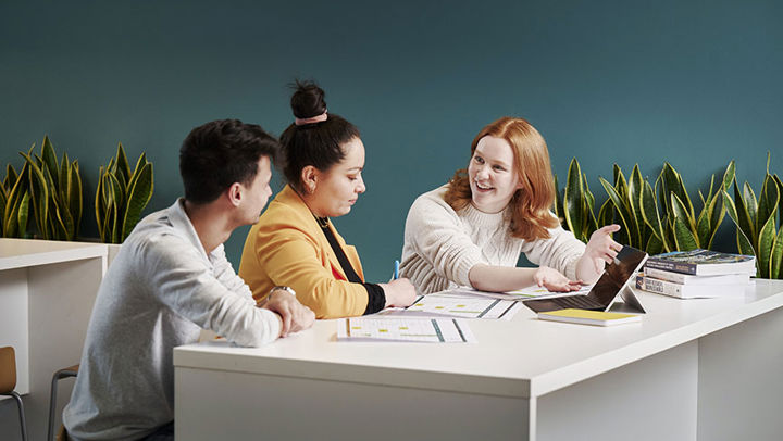 Colleagues sitting looking at data and chatting