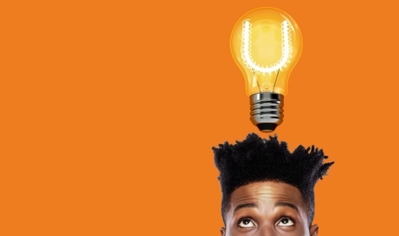 Young male with lightbulb shining above his head