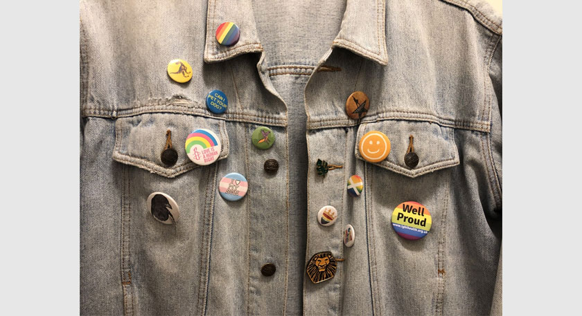 A denim jacket with lots of colourful badges