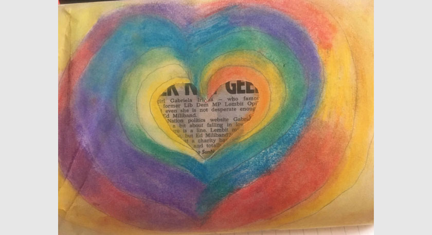 A rainbow heart with a paper cutting in the middle
