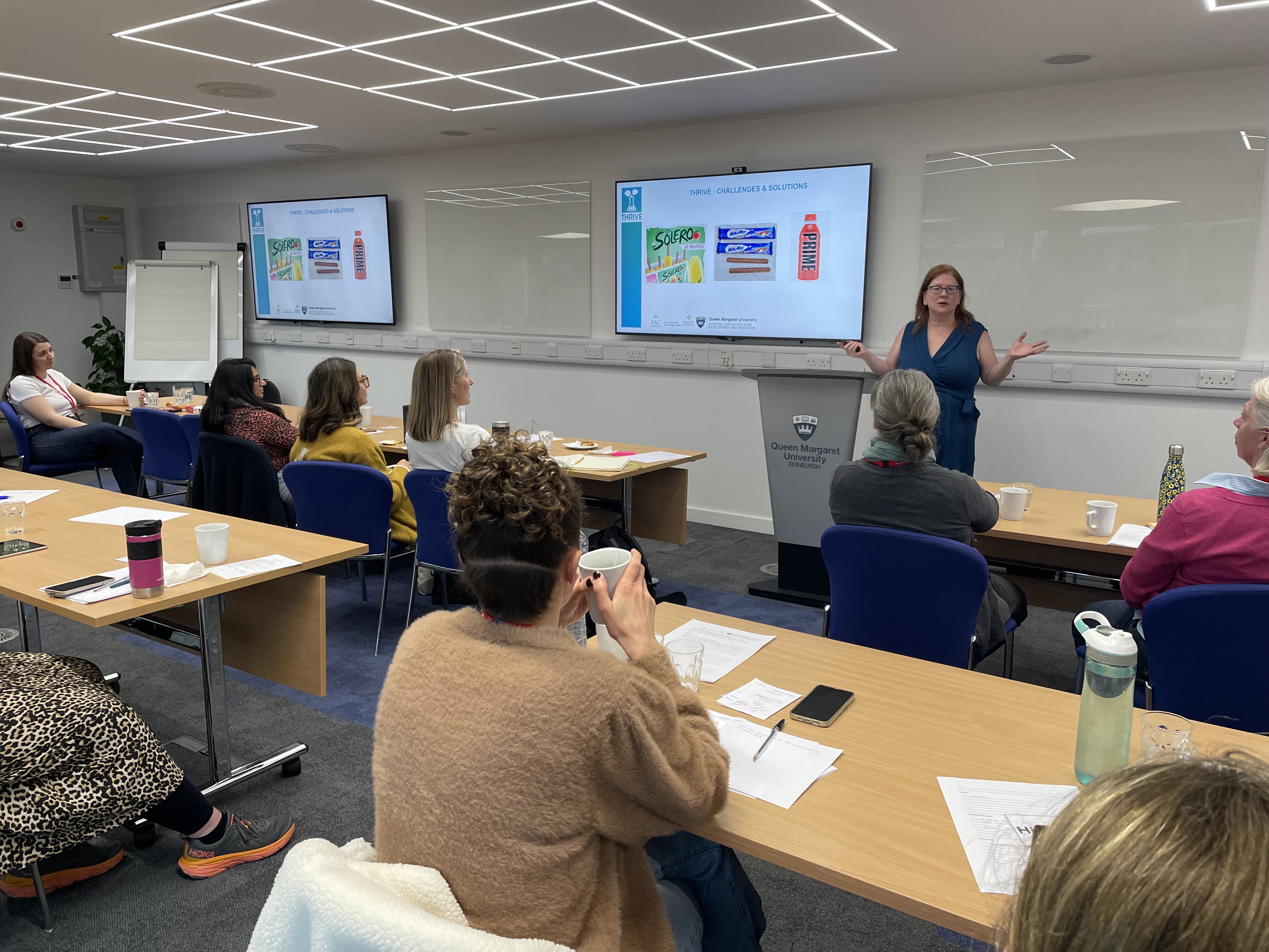 woman presenting on product development to an audience