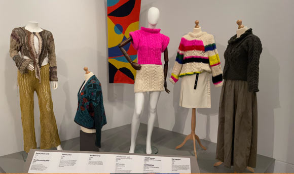 A series of mannequins wearing different handmade items of clothing.