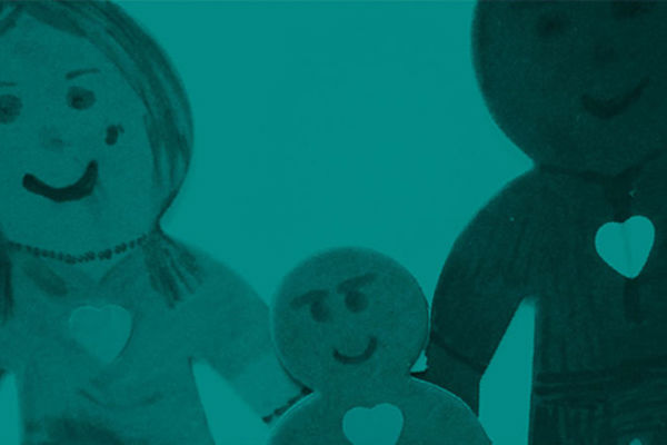 B+W photo of a child's drawing of a family with hearts on their chests