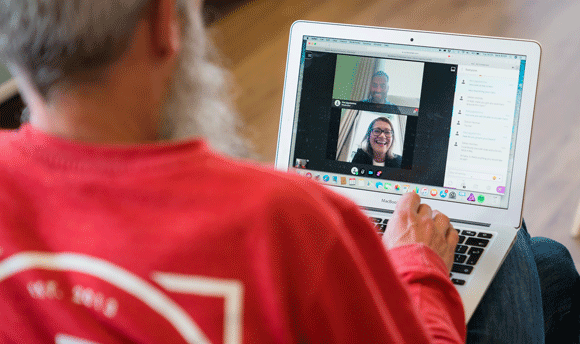 Man having an online discussion with colleagues or classmates