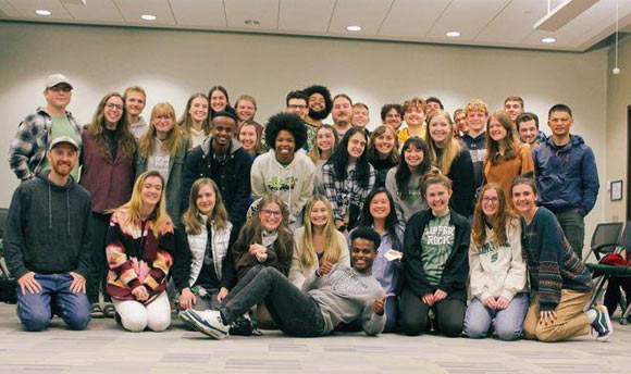 Dozens of students posing for a group photo together.