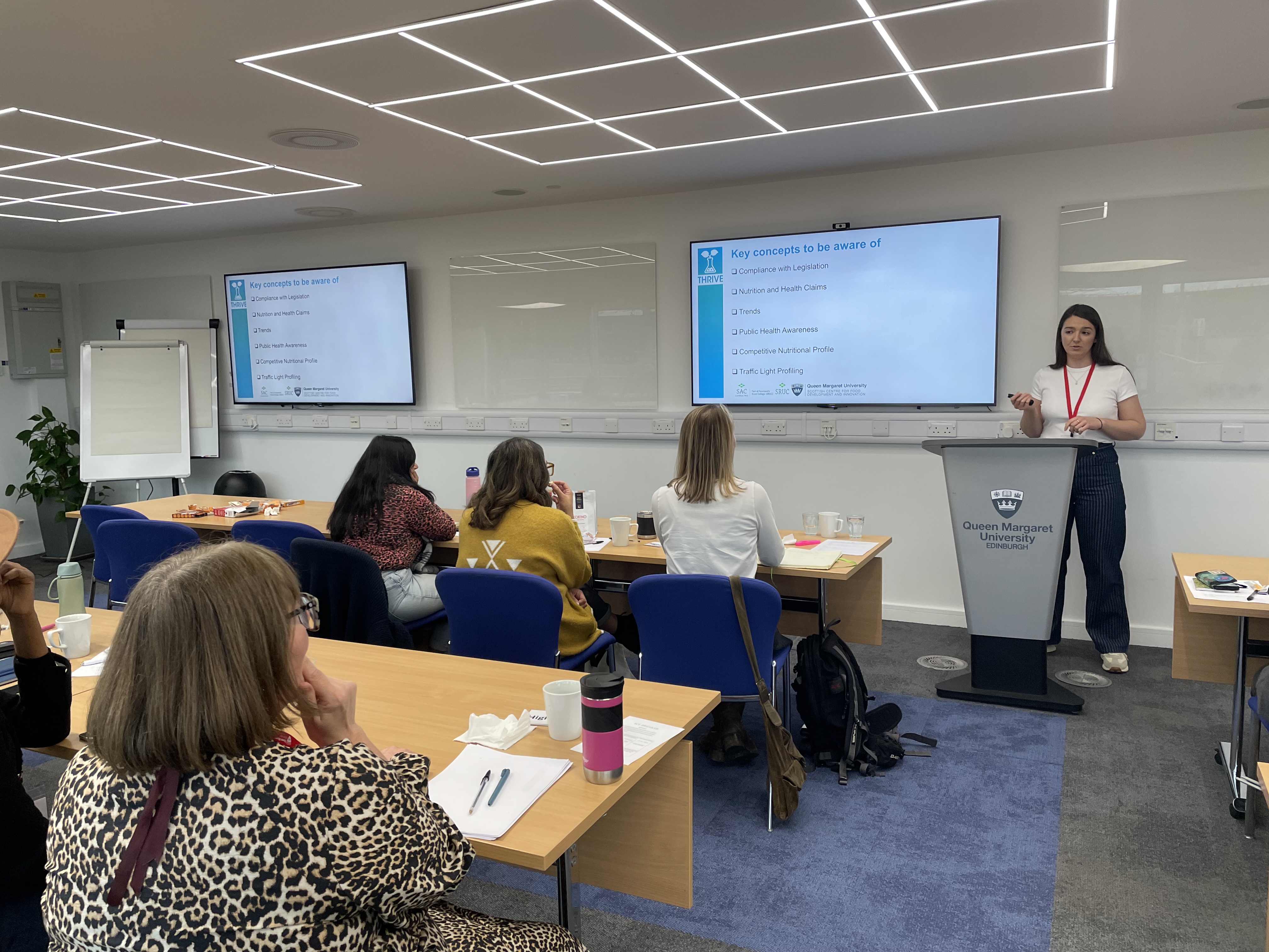 woman presenting on product development to an audience